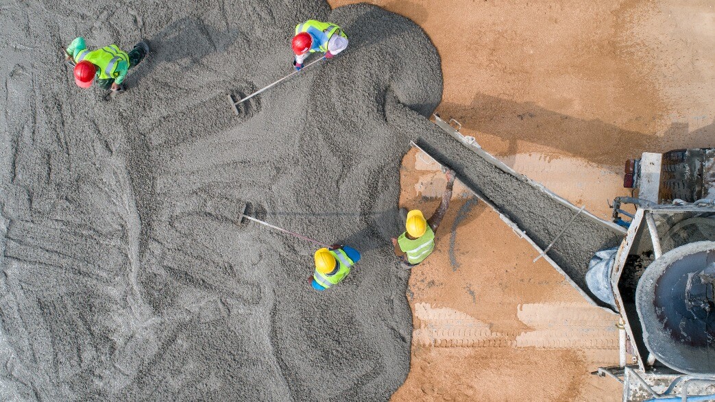 aerial view of workers pouring concrete.